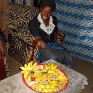 Acaa Margret used her $110 CAD loan to buy a silo grain storage to store her crops after harvest, to rent a plot of land to plant groundnuts, and to buy more sweet bananas which she sells from home.